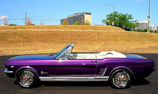That white leather interior sure does pop with this shiny plum ‘66 vert.